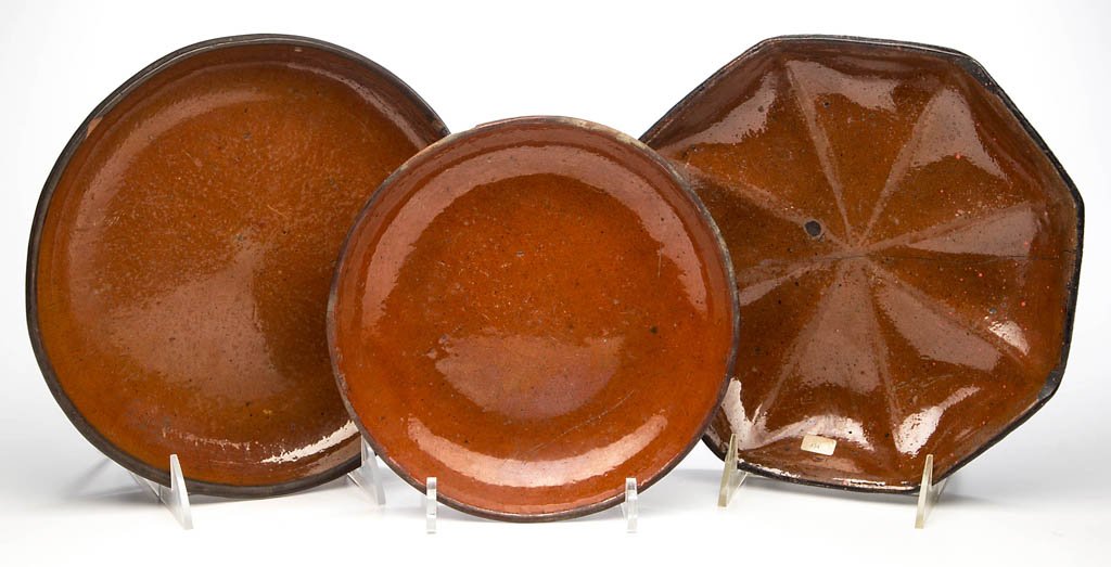 STAMPED BELL FAMILY, WAYNESBORO, PENNSYLVANIA: STAMPED BELL FAMILY, WAYNESBORO, PENNSYLVANIA EARTHENWARE / REDWARE PLATES, LOT OF THREE, lead-glazed, comprising one large circular example stamped "JOHN W. BELL / Waynesboro, Pa", and one small circ