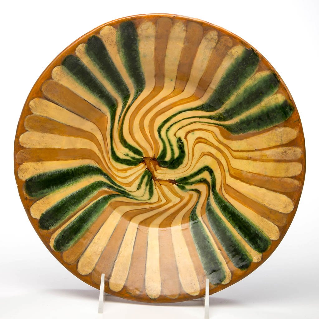 MORAVIAN SLIP-DECORATED EARTHENWARE / REDWARE DISH: MORAVIAN SLIP-DECORATED EARTHENWARE / REDWARE DISH, lead-glazed, tapered sides with rim rounded to underside, yellow and green swirled stripe slip decoration to entire face. Probably Bethabara, North