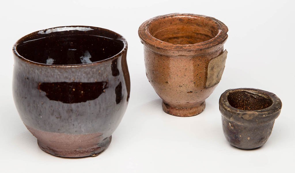 AMERICAN MINIATURE EARTHENWARE / REDWARE CROCKS, LOT OF: AMERICAN MINIATURE EARTHENWARE / REDWARE CROCKS, LOT OF THREE, manganese- and lead-glazed, each of wide-mouth form, two with squared rim. 19th century. 1" to 2" H. Provenance: From a New York City col