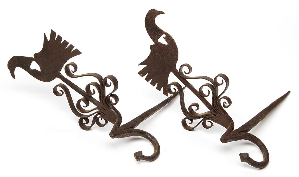 WROUGHT-IRON HORIZONTAL FIGURAL STICKING TOMMY / JAMB: WROUGHT-IRON HORIZONTAL FIGURAL STICKING TOMMY / JAMB HOOK, PAIR, central shaft terminating and depicting a bird with cut-out hearts to neck, each side of shaft with curled bands of ornamentation, und