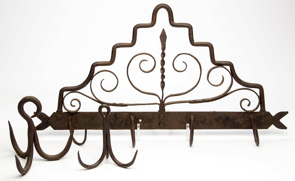WROUGHT-IRON HOOKS, LOT OF THREE: WROUGHT-IRON HOOKS, LOT OF THREE, comprising two three-prong examples with hanging ring; and a stylized scroll patterned wall rack with a spiraling medial, bottom band with four attached curved hooks.