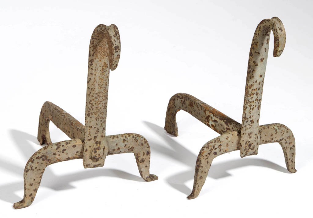 SOUTHERN WROUGHT-IRON PAIR OF ANDIRONS: SOUTHERN WROUGHT-IRON PAIR OF ANDIRONS, each blade-style shaft ending in a forward tipped scroll, raised on low-arched legs with slight feet, heavy log supports riveted to shafts. Original surfaces. F