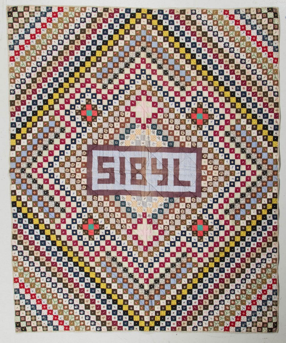 AMERICAN TRIP AROUND THE WORLD PIECED CRIB QUILT: AMERICAN TRIP AROUND THE WORLD PIECED CRIB QUILT, various prints and solids, medial with a rectangle and "SIBYL", each corner with a printed shield and "PEACE 1876", light brown print backing and bord