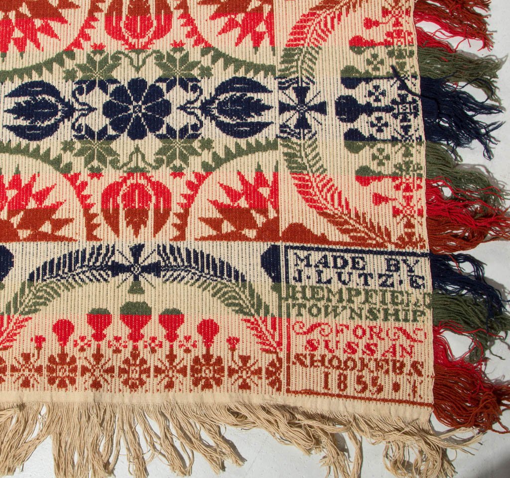 PENNSYLVANIA SIGNED JACOB LUTZ JACQUARD COVERLET: PENNSYLVANIA SIGNED JACOB LUTZ JACQUARD COVERLET, two joined panels, blue, green, red and white, alternating bands of sunburst, stylized tulips with rosettes and snowflakes, three sides with scalloped