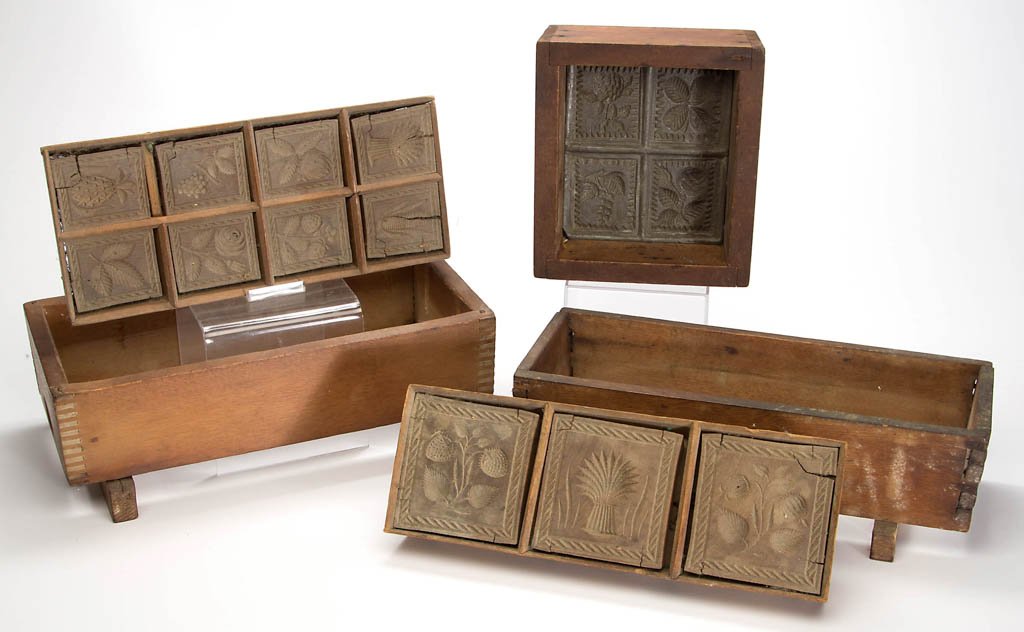 ASSORTED CARVED TREEN AND METAL BUTTER MOLDS, LOT OF: ASSORTED CARVED TREEN AND METAL BUTTER MOLDS, LOT OF THREE, rectangular forms with various floral, fruit, and grain patterns, comprising two wood and a cast-metal example in a three, four, and eight p