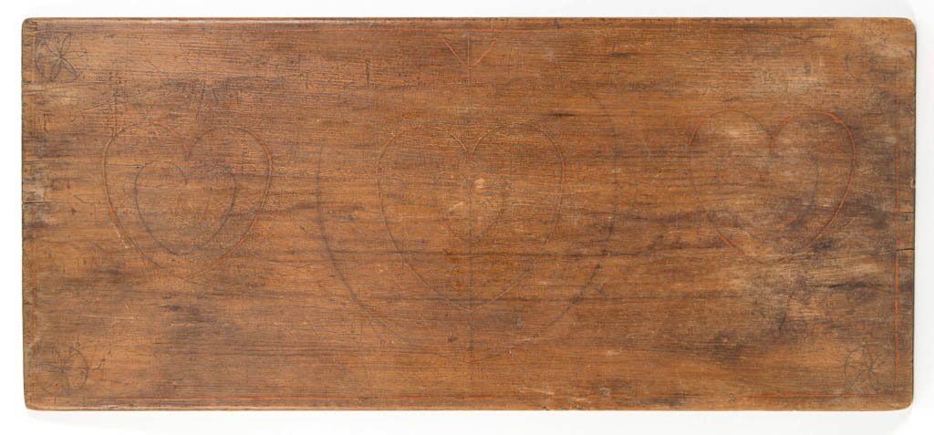 AMERICAN PAINT-DECORATED PINE SEWING BOARD: AMERICAN PAINT-DECORATED PINE SEWING BOARD, incised and paint-decorated with folk art design of three hearts framed by corner rosettes and line edging. Original worn surface. Possibly Pennsylvania or 