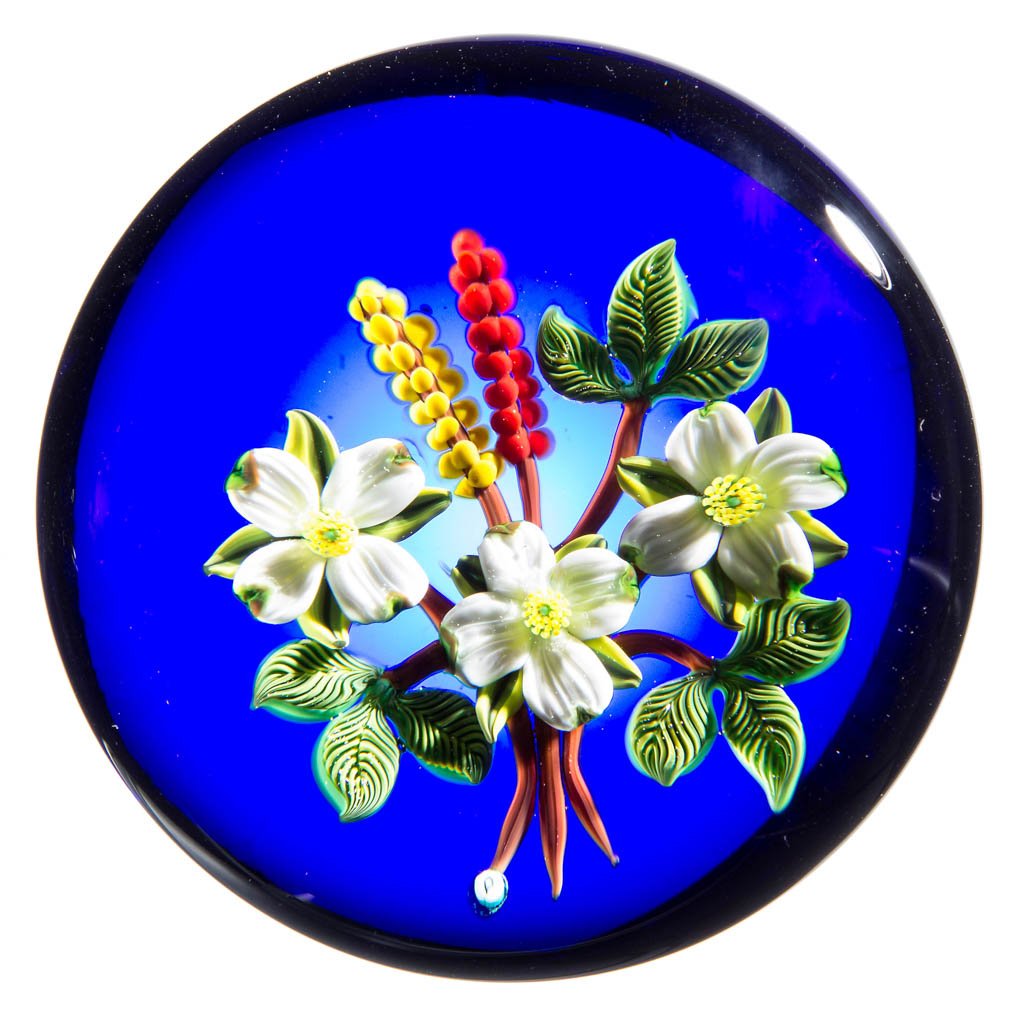 JOHN PARSLEY STUDIO ART GLASS LAMPWORK PAPERWEIGHT: JOHN PARSLEY STUDIO ART GLASS LAMPWORK PAPERWEIGHT, depicting white dogwood flowers on a blue background, signed and dated, signature "P" cane visible. 1989. 2 1/2" D. Provenance: From a private colle