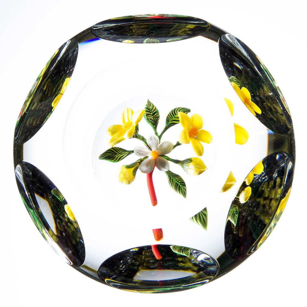 JOHN PARSLEY STUDIO ART GLASS LAMPWORK PAPERWEIGHT: JOHN PARSLEY STUDIO ART GLASS LAMPWORK PAPERWEIGHT, depicting yellow and white flowers, faceted, signature "P" cane on the underside of decoration, signed and dated. 1989. 2 1/2" D. Provenance: From a