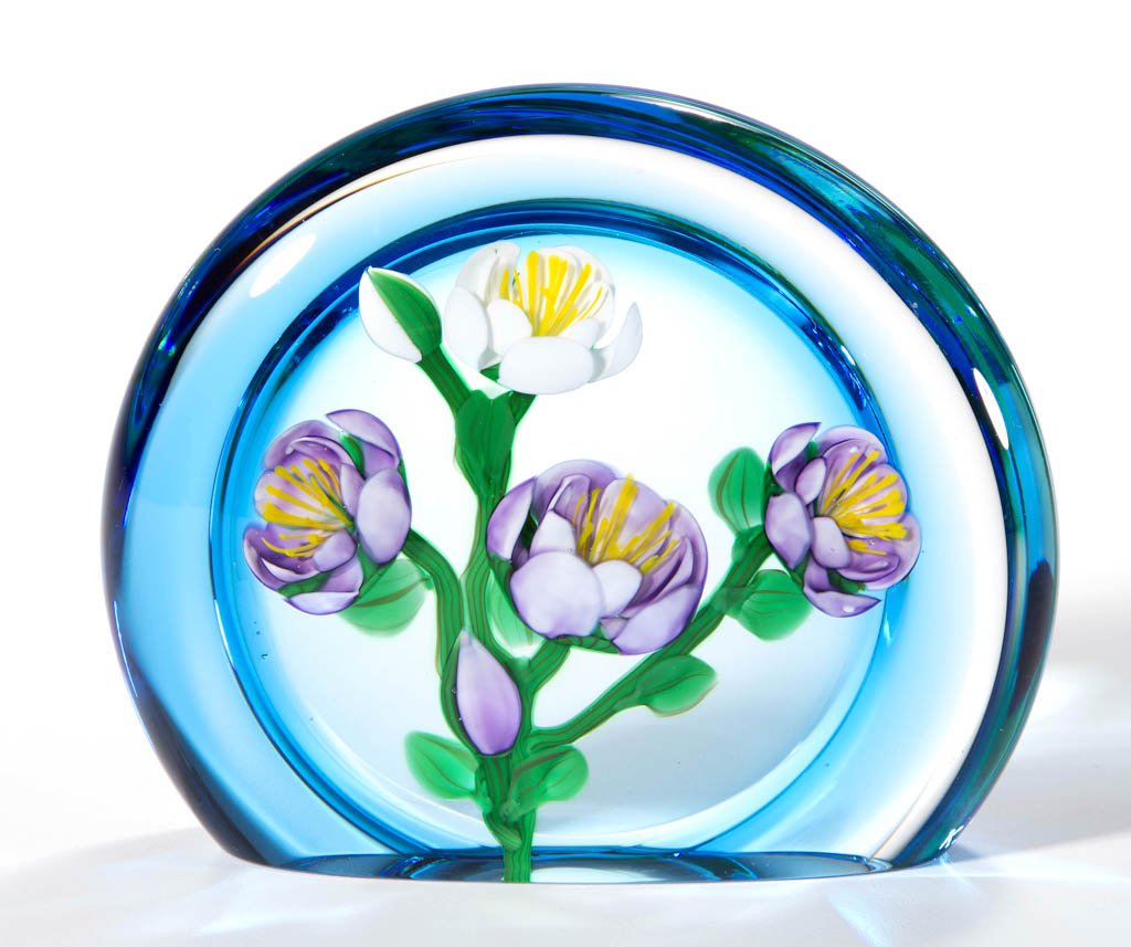 KEN ROSENFELD STUDIO ART GLASS LAMPWORK MAGNUM: KEN ROSENFELD STUDIO ART GLASS LAMPWORK MAGNUM PAPERWEIGHT, depicting lavender and white flowers in front on a blue border, signed and dated. 1989. 4 1/4" D. Provenance: From a private collection.