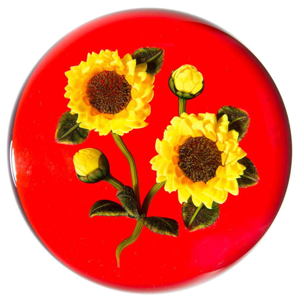 KEN ROSENFELD STUDIO ART GLASS LAMPWORK PAPERWEIGHT: KEN ROSENFELD STUDIO ART GLASS LAMPWORK PAPERWEIGHT, depicting sunflowers on a red background, signed and dated, signature "R" cane visible. 1998. 3 1/4" D. Provenance: From a private collection.