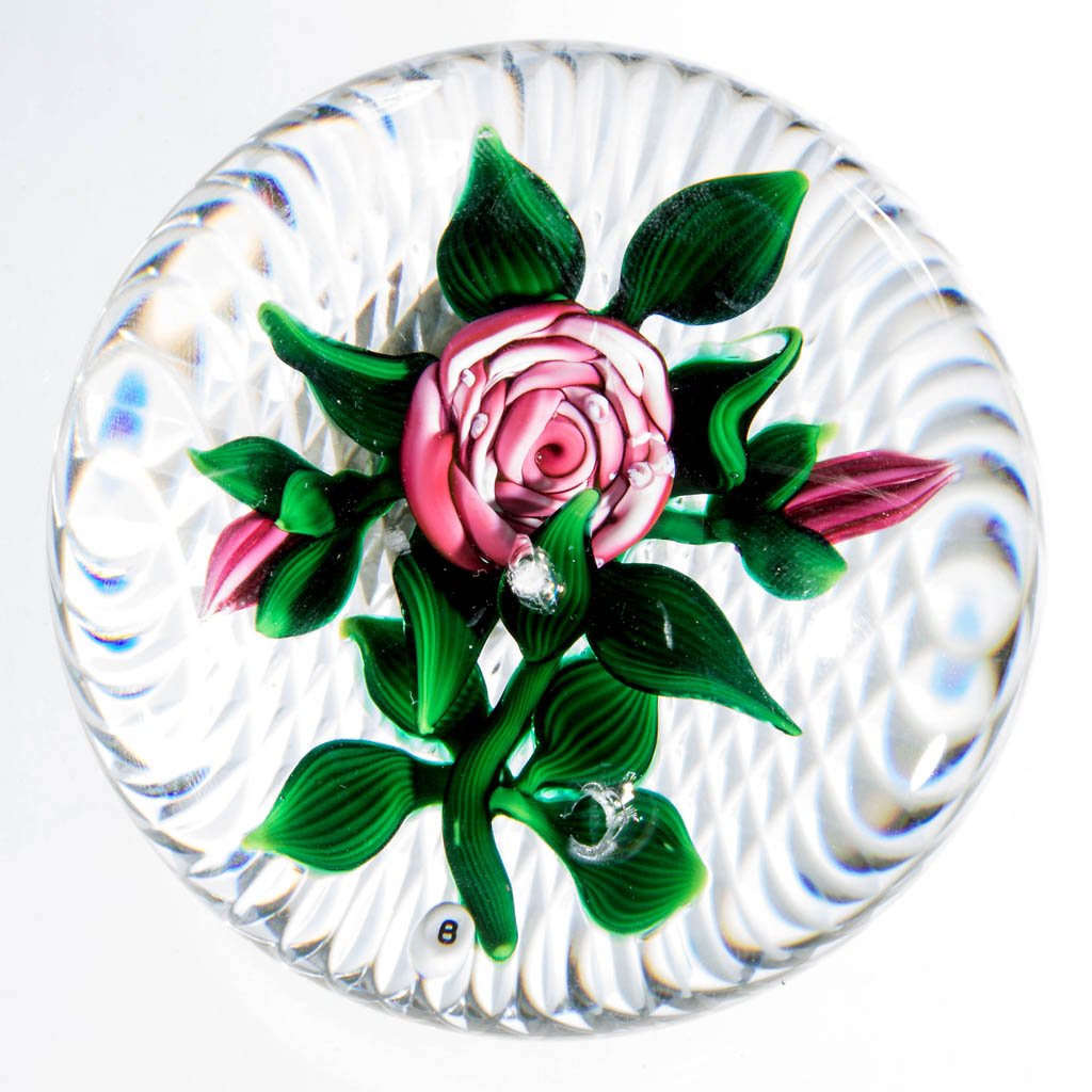 RAY BANFORD STUDIO ART GLASS LAMPWORK MAGNUM: RAY BANFORD STUDIO ART GLASS LAMPWORK MAGNUM PAPERWEIGHT, depicting a pink rose on a cross-hatch cut base, signature "B" cane visible. Fourth quarter 20th century. 3 1/2" D. Provenance: From a private