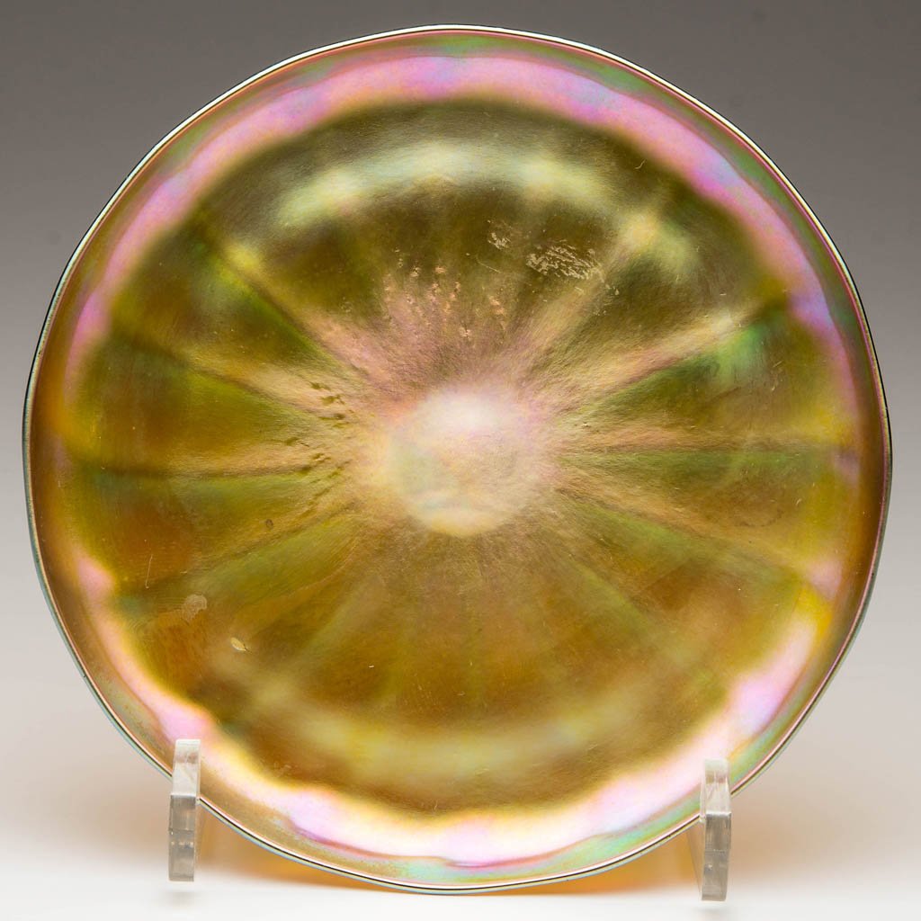 QUEZAL RIB-OPTIC TRAY: QUEZAL RIB-OPTIC TRAY, gold iridescent, with 16 ribs, signed "QUEZAL" within the polished pontil mark. Quezal Art Glass and Decorating Co. First quarter 20th century. 6" D.