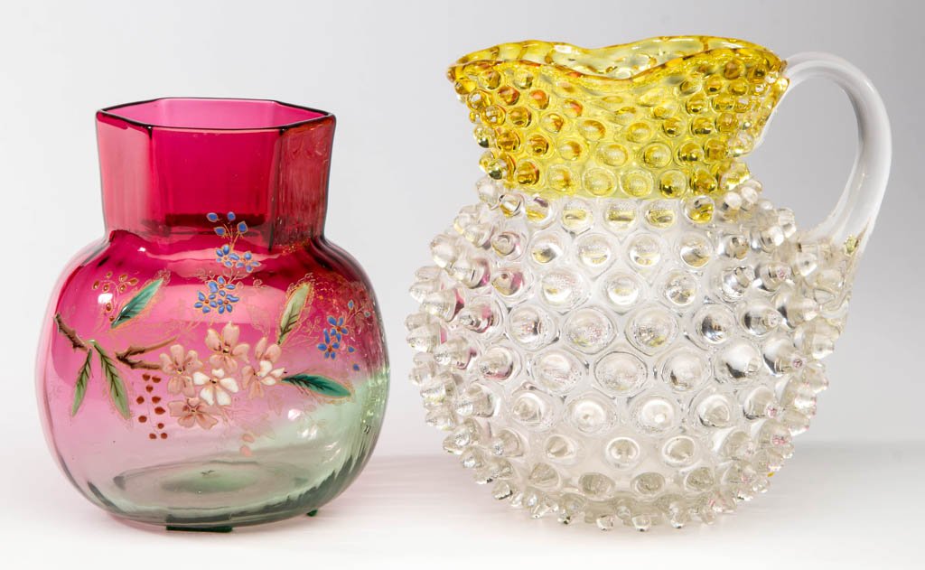ASSORTED GLASS ARTICLES, LOT OF TWO: ASSORTED GLASS ARTICLES, LOT OF TWO, comprising a Hobbs Dewdrop Francesware square-neck pitcher, and a cranberry to green bulbous vase with hexagonal neck, and polychrome-enamel floral decoration. Fou
