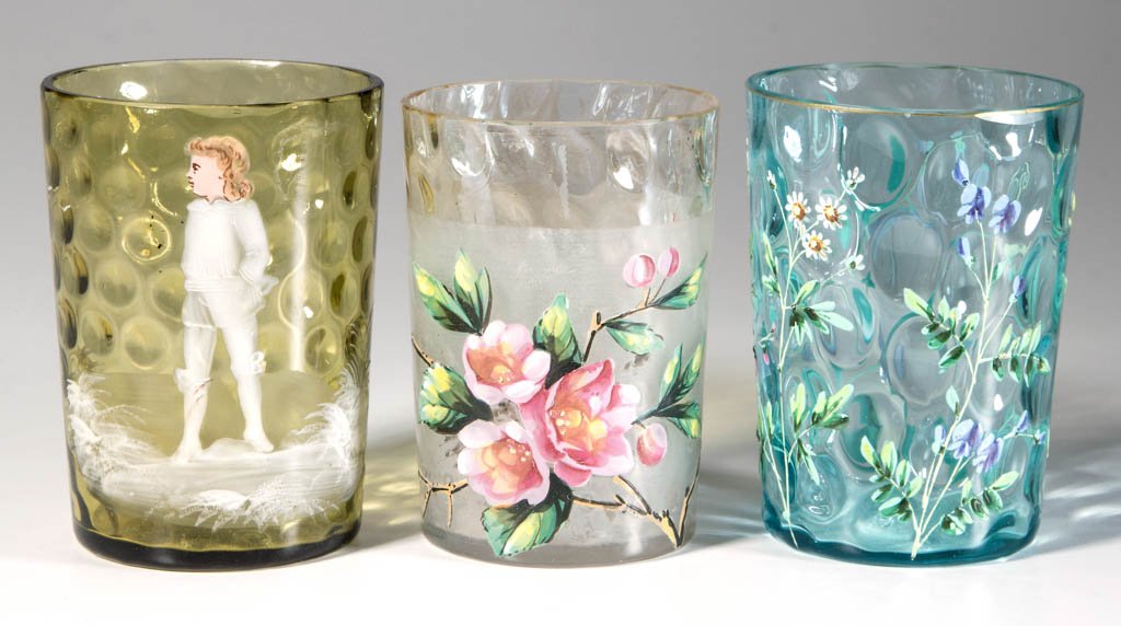 ASSORTED INVERTED THUMBPRINT / SPOT-OPTIC TUMBLERS, LOT: ASSORTED INVERTED THUMBPRINT / SPOT-OPTIC TUMBLERS, LOT OF THREE, colorless, amber and blue, comprising a Midwest Pomona with polychrome-enamel floral decoration, a so-called Mary Gregory, and a polyc