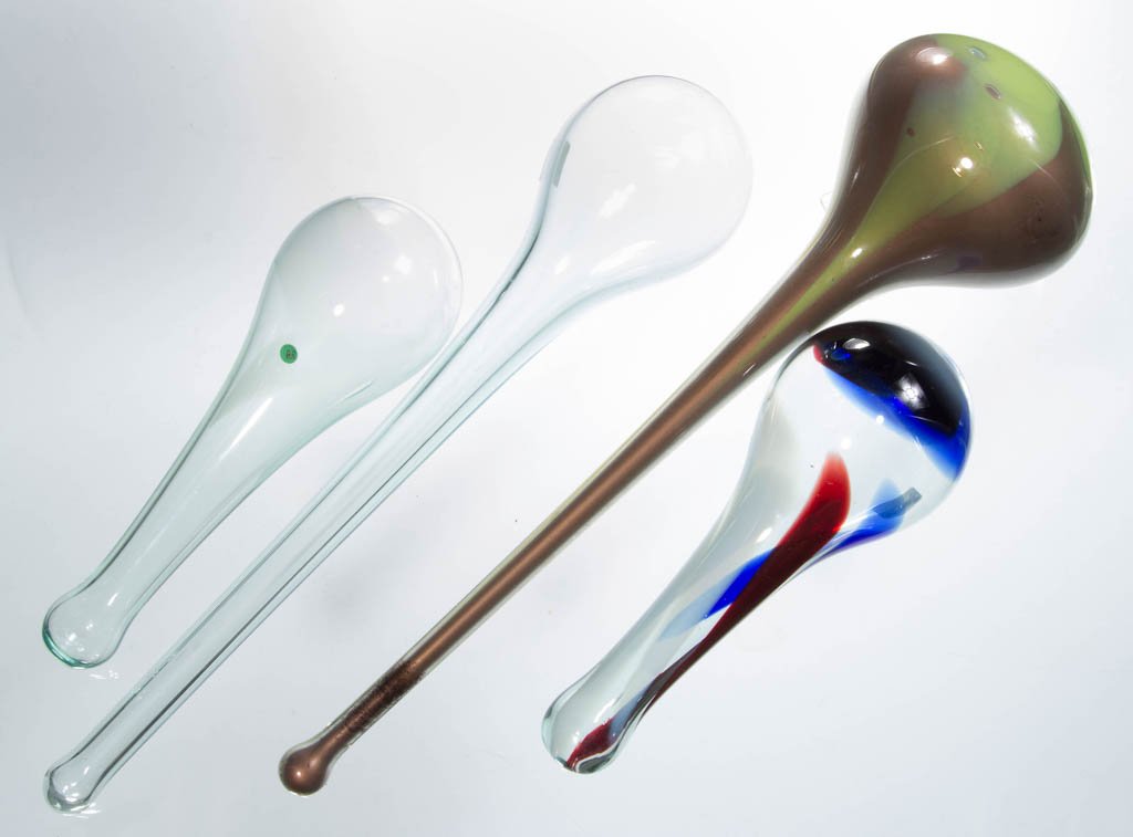 FREE-BLOWN GLASS DARNING BALLS, LOT OF FOUR: FREE-BLOWN GLASS DARNING BALLS, LOT OF FOUR, including a green and orange mottled example with copper-powder interior, and a red, white, and blue mottled example, each handle with closed end. Second h