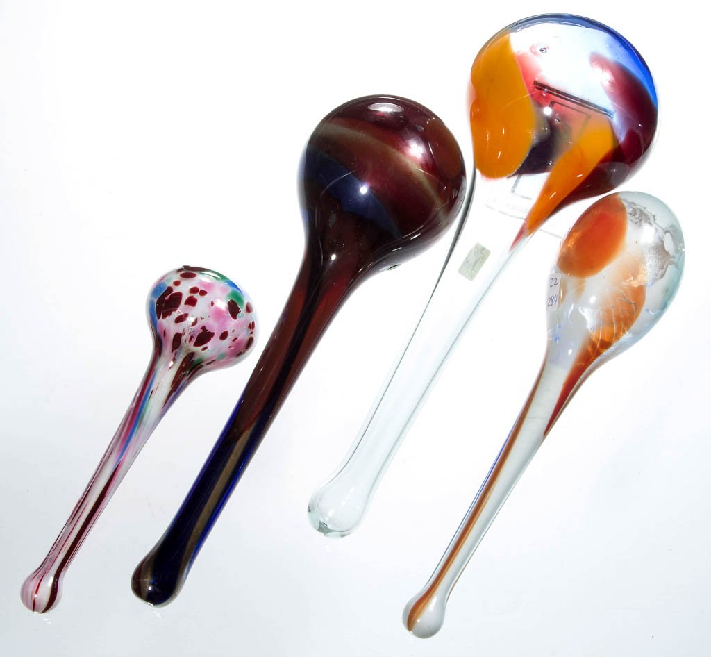 FREE-BLOWN MOTTLED GLASS DARNING BALLS, LOT OF FOUR: FREE-BLOWN MOTTLED GLASS DARNING BALLS, LOT OF FOUR, colorless with orange, ruby, blue, blood red, and green, handles with closed ends, including three with powdered interiors. Second half 19th centur