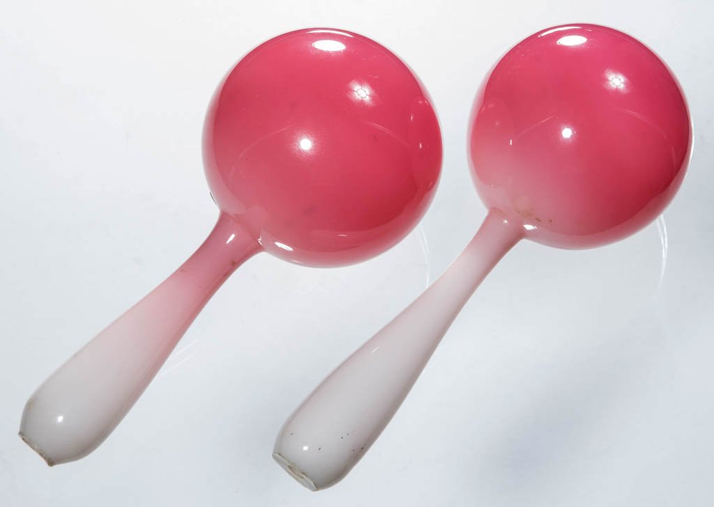 FREE-BLOWN PEACHBLOW GLASS DARNING BALLS, LOT OF TWO: FREE-BLOWN PEACHBLOW GLASS DARNING BALLS, LOT OF TWO, glossy rose to pale pink, each handle with open-pontil end. Libbey Glass Co. or Mt. Washington Glass Co., probably made on-site at the 1893 Chicag