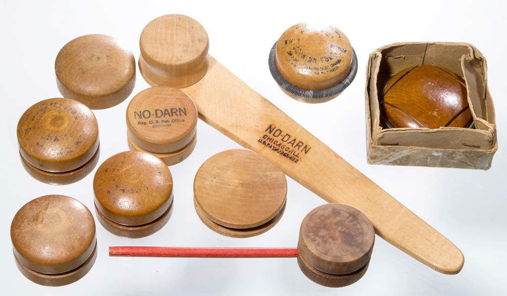 ASSORTED WHEEL / DOOR-KNOB FORM DARNERS / MENDERS, LOT: ASSORTED WHEEL / DOOR-KNOB FORM DARNERS / MENDERS, LOT OF TEN, various woods, including "The Ebor Darner" with original box, and two "No-Darn" examples, one with attached paddle-form handle. 20th cent