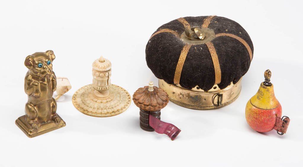 ASSORTED FIGURAL SEWING TAPE MEASURERS, LOT OF FIVE: ASSORTED FIGURAL SEWING TAPE MEASURERS, LOT OF FIVE, comprising two metal examples including a crown-form with pin cushion top and a dog standing upright; two wooden examples including a pear and a ri