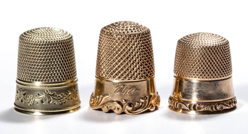 ASSORTED 14K GOLD THIMBLES, LOT OF THREE: ASSORTED 14K GOLD THIMBLES, LOT OF THREE, comprising two Ketcham & McDougal including one with Louis XV heavy scroll rim and name "Etta", and a Simons Bros. Co. example with a floral garland band with
