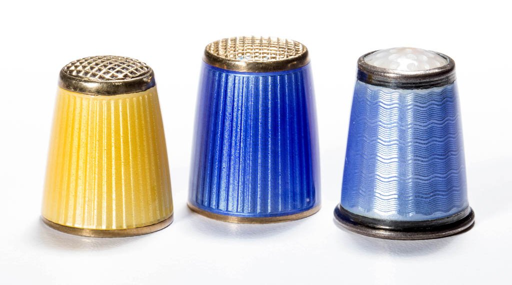 NORWEGIAN GUILLOCHE ENAMEL ON STERLING SILVER THIMBLES,: NORWEGIAN GUILLOCHE ENAMEL ON STERLING SILVER THIMBLES, LOT OF THREE, yellow, dark and light blue, horizontal and vertical patterns, including two David Anderson examples, including one with a moonsto