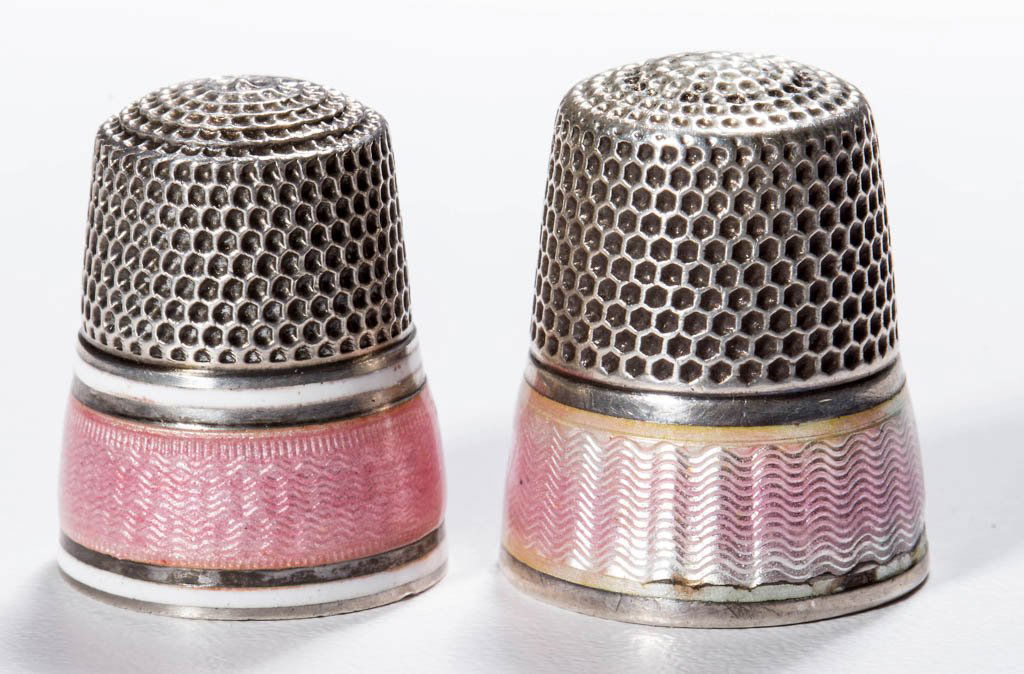 AMERICAN ENAMEL ON STERLING SILVER THIMBLES, LOT OF TWO: AMERICAN ENAMEL ON STERLING SILVER THIMBLES, LOT OF TWO, pink horizontal wave bands, comprising a Ketcham & McDougall example and a Simons example with additional white enamel narrow bands, each with