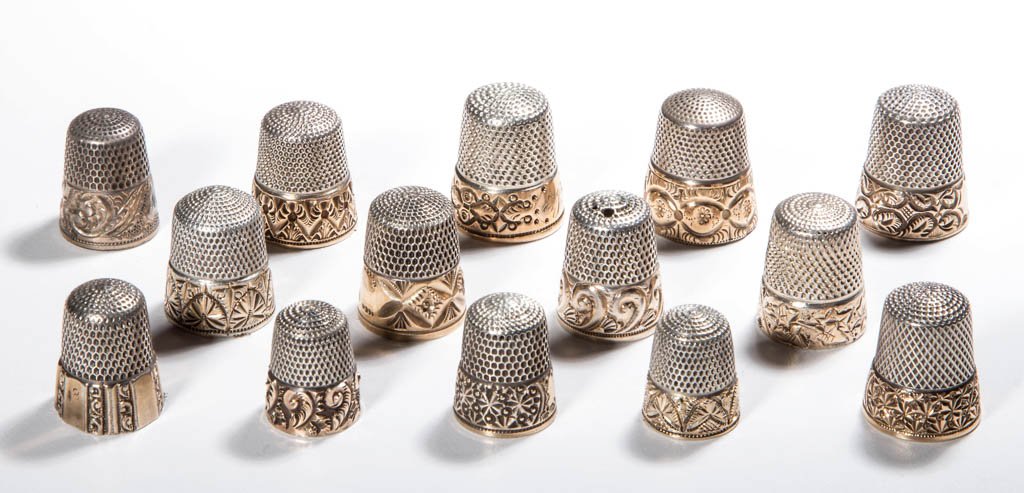 SILVER-LIKE WITH GOLD BAND THIMBLES, LOT OF 14: SILVER-LIKE WITH GOLD BAND THIMBLES, LOT OF 14, various chased and engraved floral and scroll patterns, including nine Simons Brothers with maker's mark in apex. Late 19th and 20th century. Various si