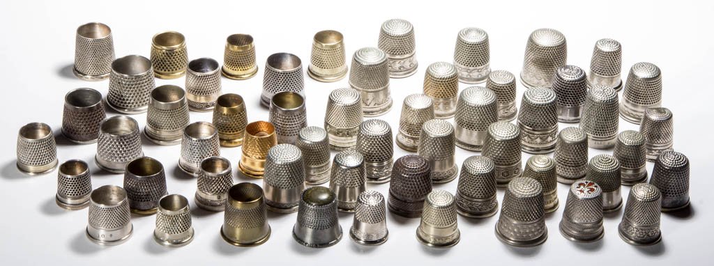 ASSORTED METALS UTILITARIAN THIMBLES, LOT OF 55: ASSORTED METALS UTILITARIAN THIMBLES, LOT OF 55, brass and steel, various patterns including floral, scroll and souvenir bands, including 21 tailor's examples. Late 19th and 20th century. Various size