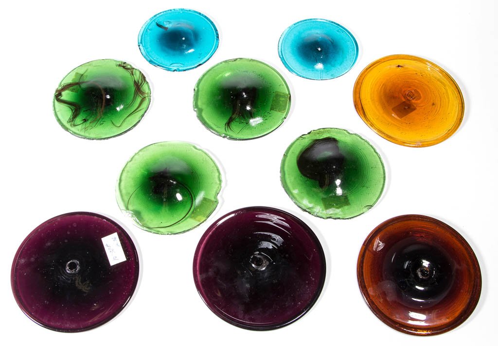 ASSORTED GLASS BULL'S EYE PANES, LOT OF TEN: ASSORTED GLASS BULL'S EYE PANES, LOT OF TEN, various shades of amber, amethyst, green, and teal, several with blood red striations, four with rough pontil mark and tooled rim. 19th and/or 20th century