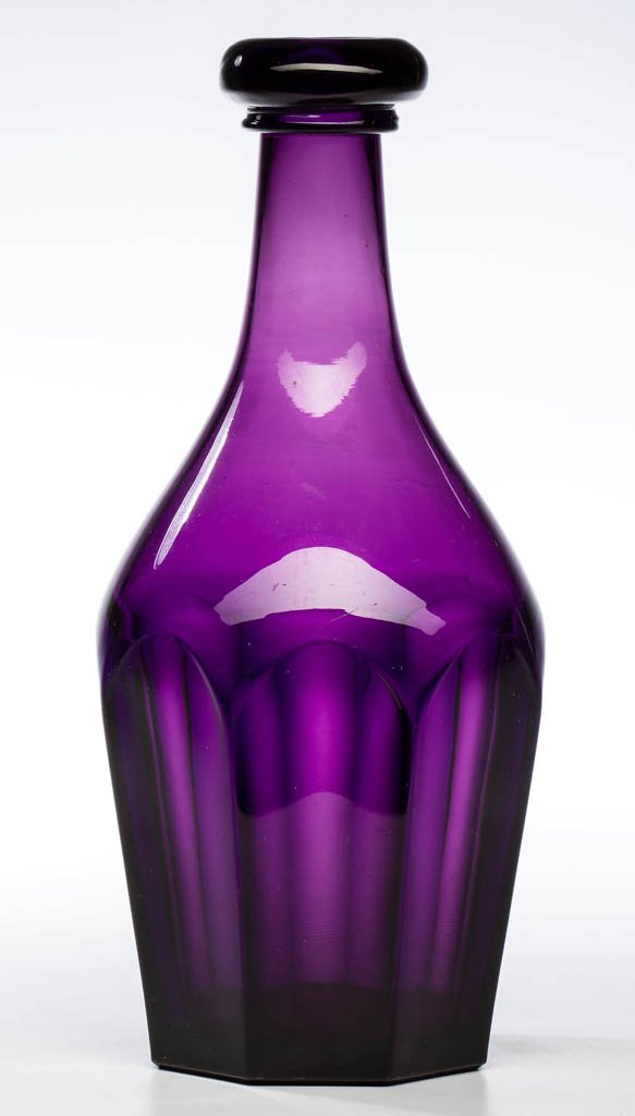 PRESSED EIGHT-FLUTE QUART DECANTER: PRESSED EIGHT-FLUTE QUART DECANTER, brilliant amethyst, Prussian form with an applied bar lip, plain neck, and polished pontil mark. New England or Pittsburgh area. Circa 1850-1870. 10 1/2" H, 3 3/4" 