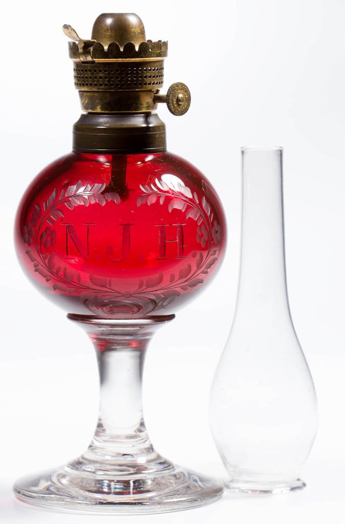 FREE-BLOWN ENGRAVED MINIATURE STAND LAMP: FREE-BLOWN ENGRAVED MINIATURE STAND LAMP, ruby globular-form font, colorless solid stem and circular foot with slightly rough pontil mark, font engraved "N. J. H." within foliate wreath, No. 1 fine-li