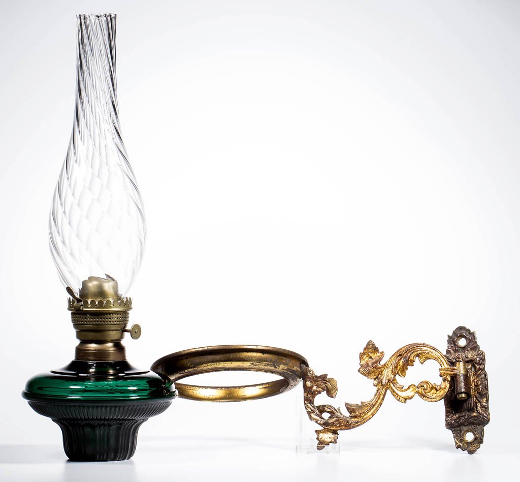 RIBBED COLORED GLASS FONT BRACKET LAMP: RIBBED COLORED GLASS FONT BRACKET LAMP, deep emerald green font with panels and ribs pattern, No. 2 fine-line collar, supported in a gilded brass frame with simple foliage pattern and cast brass wall 