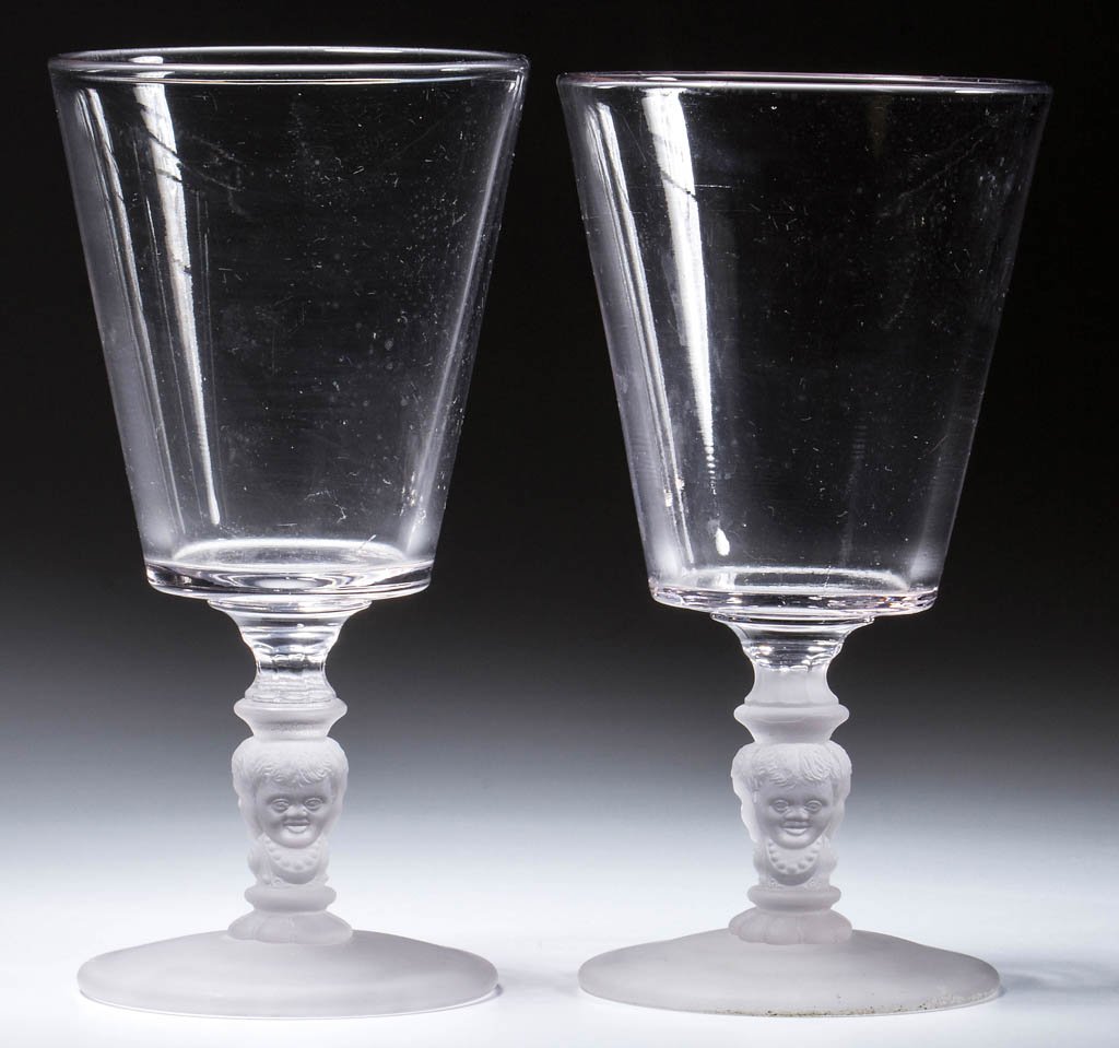 BABY FACE GOBLETS, LOT OF TWO: BABY FACE GOBLETS, LOT OF TWO, colorless, with a frosted figural stem and foot. McKee & Brothers, Pittsburgh, PA. Fourth quarter 19th century. 6 3/8" H. Provenance: Property of Art & Kathy Green.