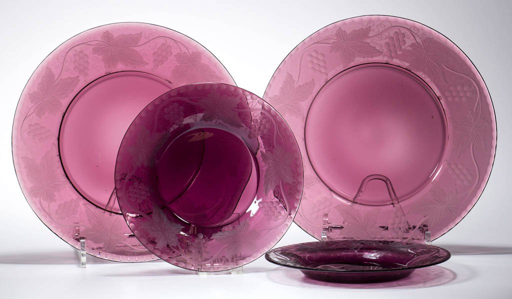 PAIRPOINT ENGRAVED PLATES, LOT OF FOUR: PAIRPOINT ENGRAVED PLATES, LOT OF FOUR, deep amethyst, each with engraved Vintage decoration around rim, polished under bases. Pairpoint Manufacturing Company. First half 20th century. 6 1/4" and 8 1/