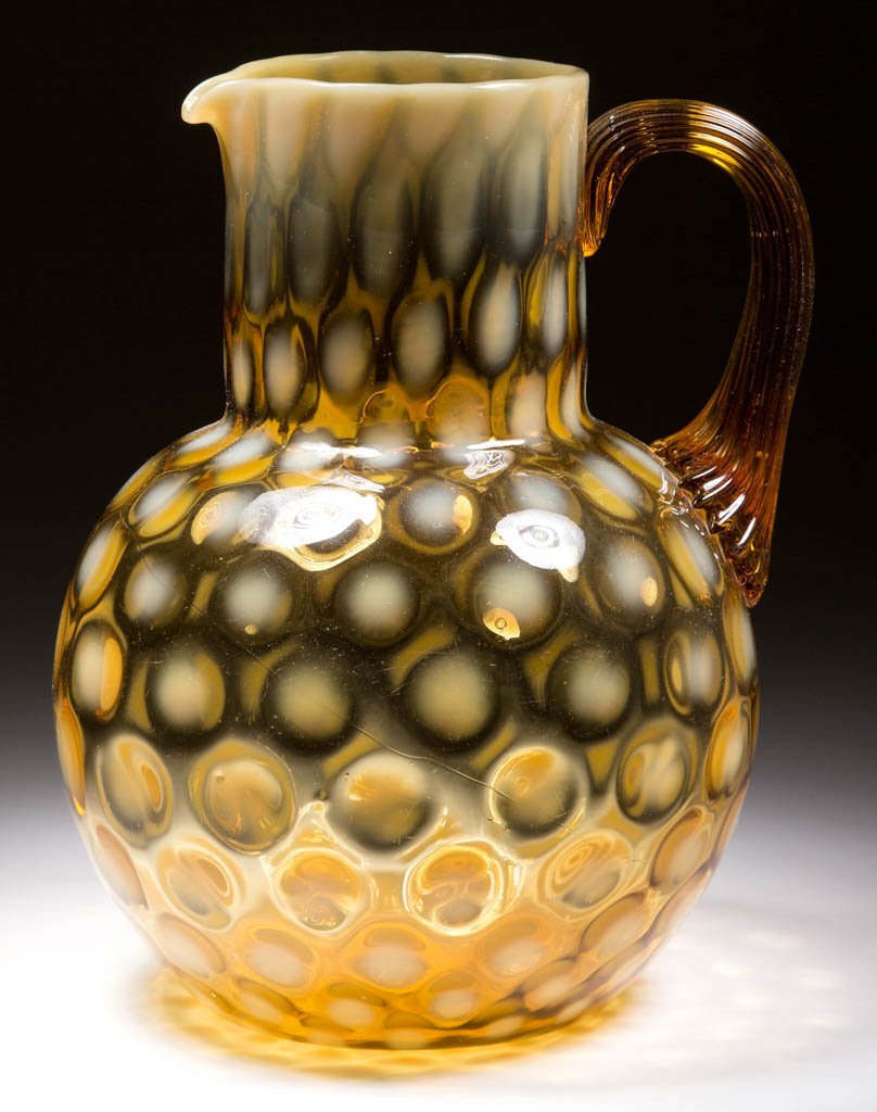 PHOENIX COINSPOT PITCHER: PHOENIX COINSPOT PITCHER, amber opalescent, circular rim, applied amber reeded handle, polished pontil mark. Phoenix Glass Co. Circa 1883-1888. 8 1/4" H. Literature: Marple - Phoenix Art Glass, p. 75,