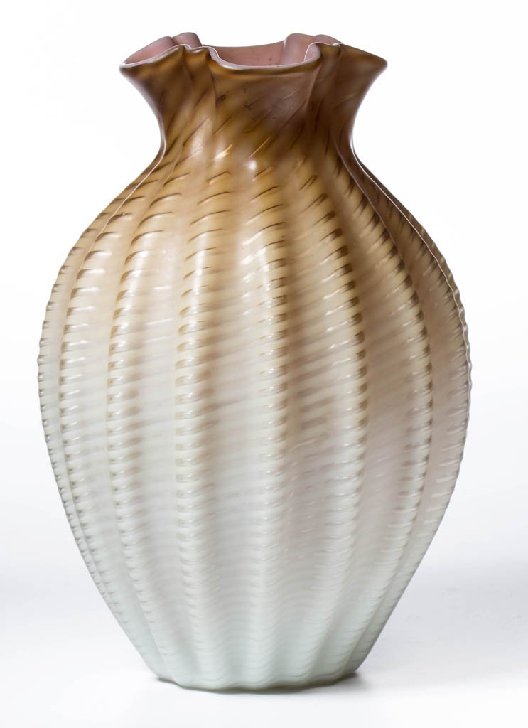 SPIRAL AIR-TRAP MOTHER-OF-PEARL SATIN GLASS VASE: SPIRAL AIR-TRAP MOTHER-OF-PEARL SATIN GLASS VASE, shaded bronze, cased peach interior, ovoid form with 16 vertical ribs and ruffled square rim, polished pontil mark. Probably Webb or Stevens & William