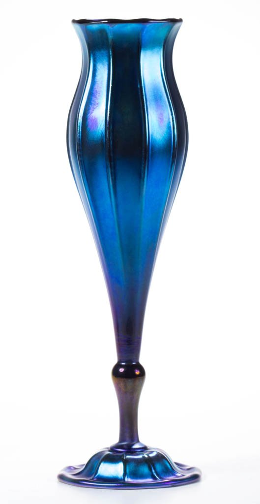 TIFFANY FAVRILE RIBBED FLORIFORM VASE: TIFFANY FAVRILE RIBBED FLORIFORM VASE, blue iridescent, having a 12-rib body with flaring rim, domed 10-rib applied foot, polished base and pontil mark, signed "1526-3380 M L.C.Tiffany-Favrile Inc." T