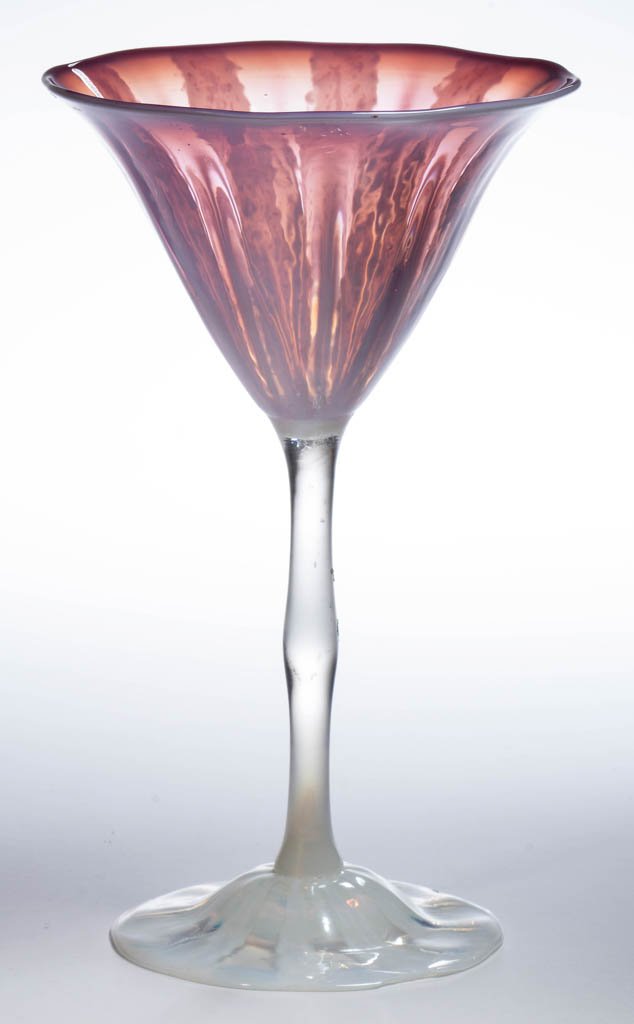 TIFFANY WISTERIA PASTEL WINE: TIFFANY WISTERIA PASTEL WINE, purple with opalescent design, having an applied stem and domed foot, signed "L.C.Tiffany Favrile." Tiffany Studios. Circa 1930. 7 3/8" H. Provenance: From the collection