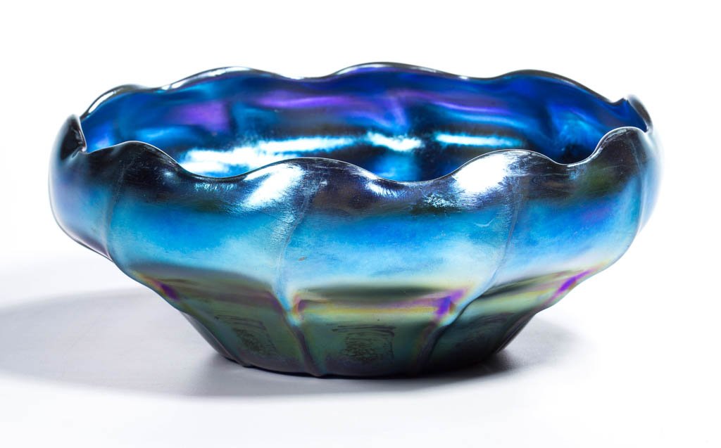 TIFFANY FAVRILE SCALLOPED-RIM BOWL: TIFFANY FAVRILE SCALLOPED-RIM BOWL, blue iridescent, ribbed pattern, with a polished base and pontil mark, signed "L.C.T Favrile." Tiffany Studios. Early 20th century. 7 1/4" DOA. Provenance: Property