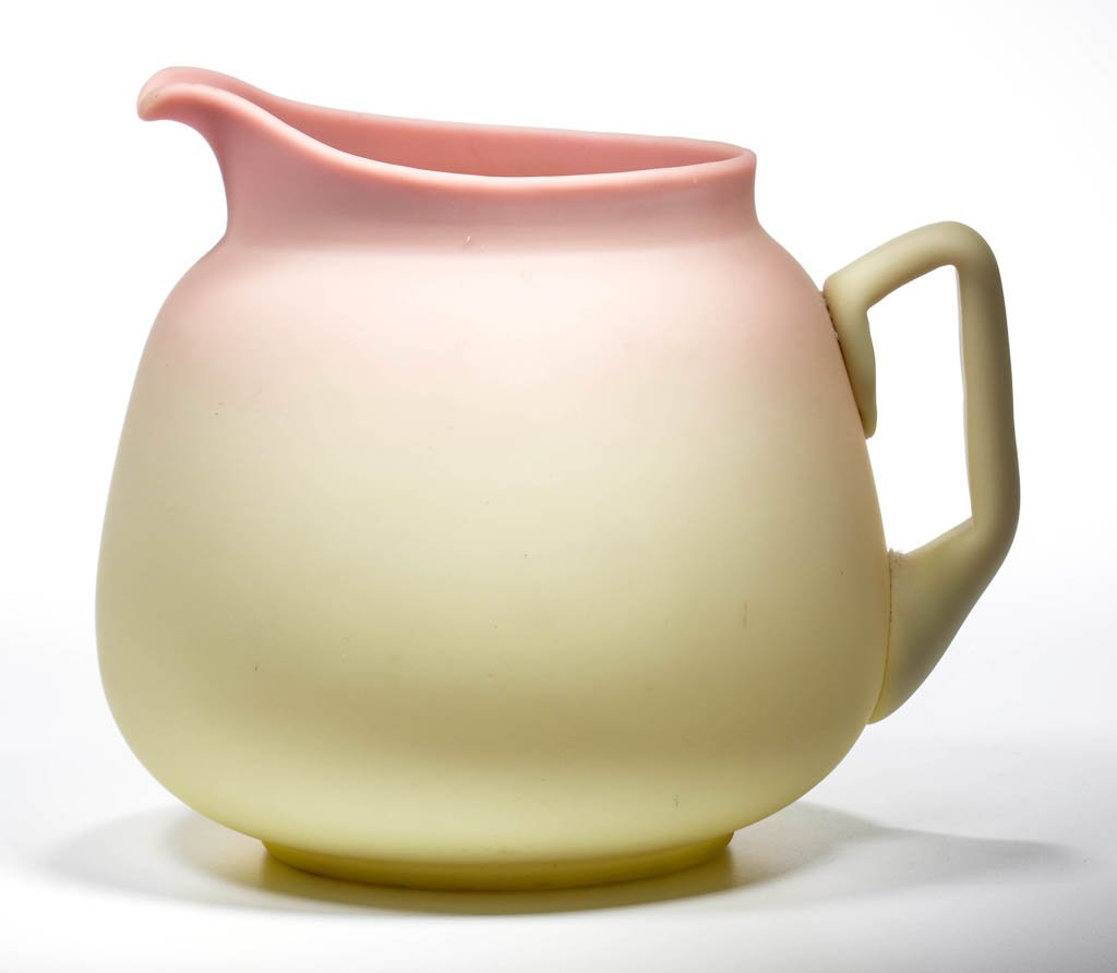 MT. WASHINGTON BURMESE PITCHER: MT. WASHINGTON BURMESE PITCHER, plush finish, No. 158 two-quart jug with applied handle, polished pontil mark. Mt. Washington Glass Co. Fourth quarter 19th century. 6 3/4" HOA. Literature: Parallels S