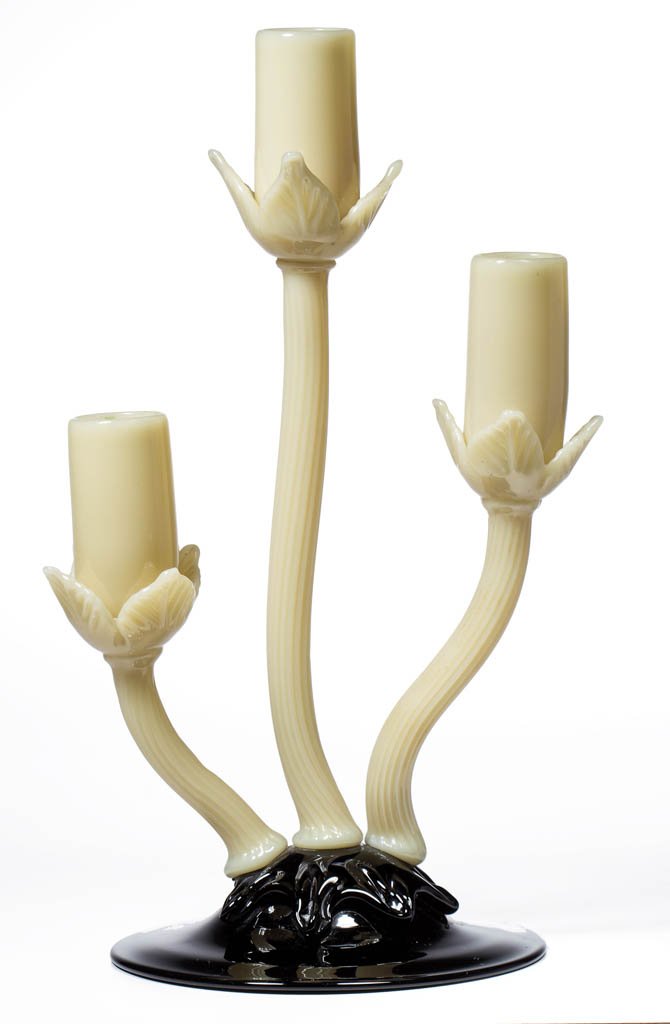 STEUBEN ART GLASS FLORIFORM THREE-LITE CANDLEHOLDER: STEUBEN ART GLASS FLORIFORM THREE-LITE CANDLEHOLDER, mirror black and ivory, shape 7317, applied base, reeded stems, and candle holders, polished pontil mark. Steuben Glass Works. Circa 1932. 10 1/2"