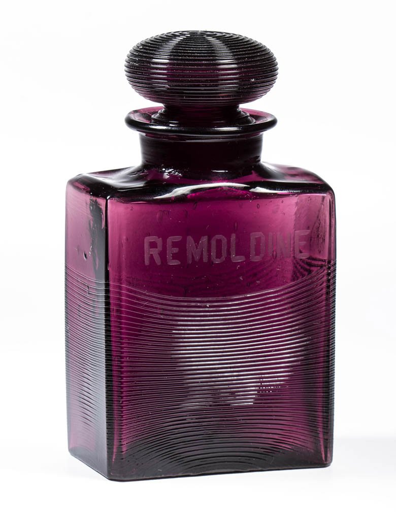 STEUBEN ART GLASS TOILETRY / DRESSER BOTTLE: STEUBEN ART GLASS TOILETRY / DRESSER BOTTLE, Amethyst, shape 6590, rectangular form with slightly draped horizontal threading, engraved "REMOLDINE" above ribs, original reeded stopper, polished pontil