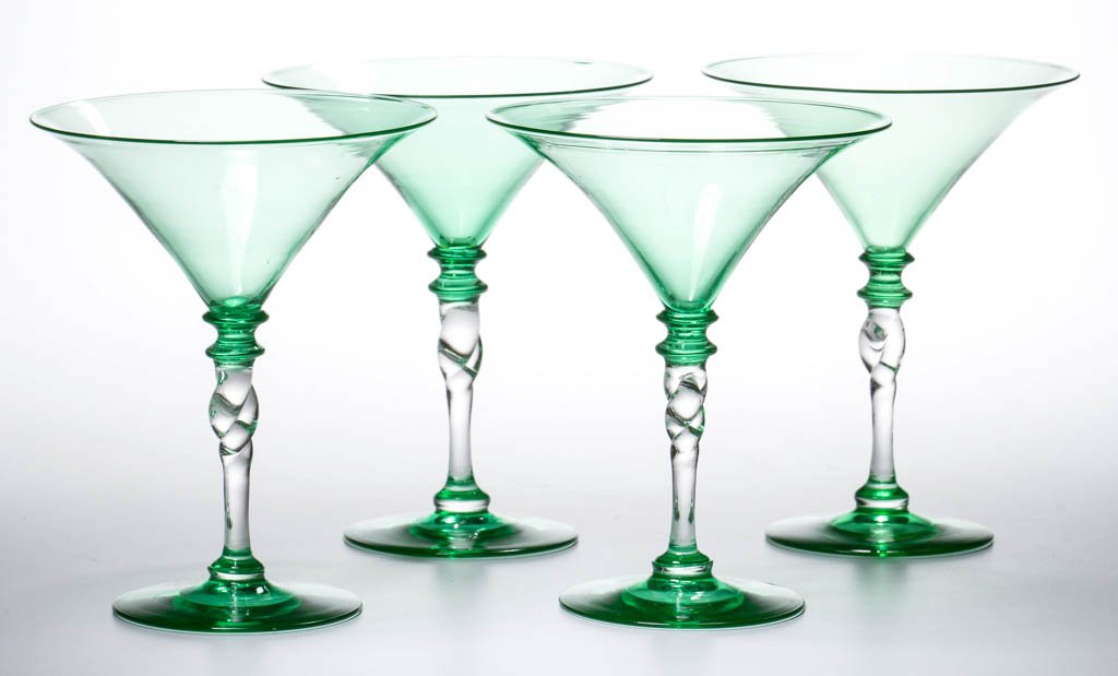 STEUBEN TWISTED STEM MARTINI GLASSES, LOT OF FOUR: STEUBEN TWISTED STEM MARTINI GLASSES, LOT OF FOUR, colorless and green, each with an applied foot and stem, and polished pontil mark, two signed. Steuben Glass Works. First half 20th century. 5 1/2" H