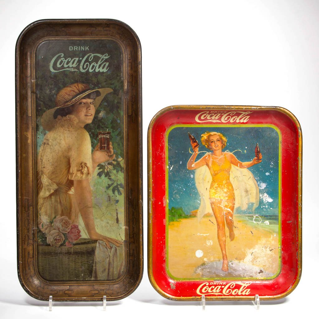 COCA-COLA ADVERTISING TIN SERVING TRAYS, LOT OF TWO: COCA-COLA ADVERTISING TIN SERVING TRAYS, LOT OF TWO, comprising a 1916 Elaine and a 1937 Girl Running on Beach. First 19" x 8 1/2". Provenance: Property of a West Virginia private collector.