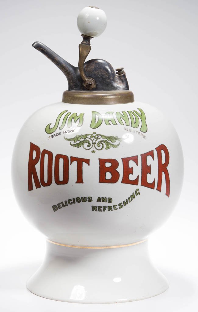 JIM DANDY ROOT BEER CERAMIC SYRUP DISPENSER: JIM DANDY ROOT BEER CERAMIC SYRUP DISPENSER, of globular form with bold red and green lettering and flared foot. Retains period pump with porcelain handle. Dated "1918" at bottom. Circa 1918. 15" HOA.