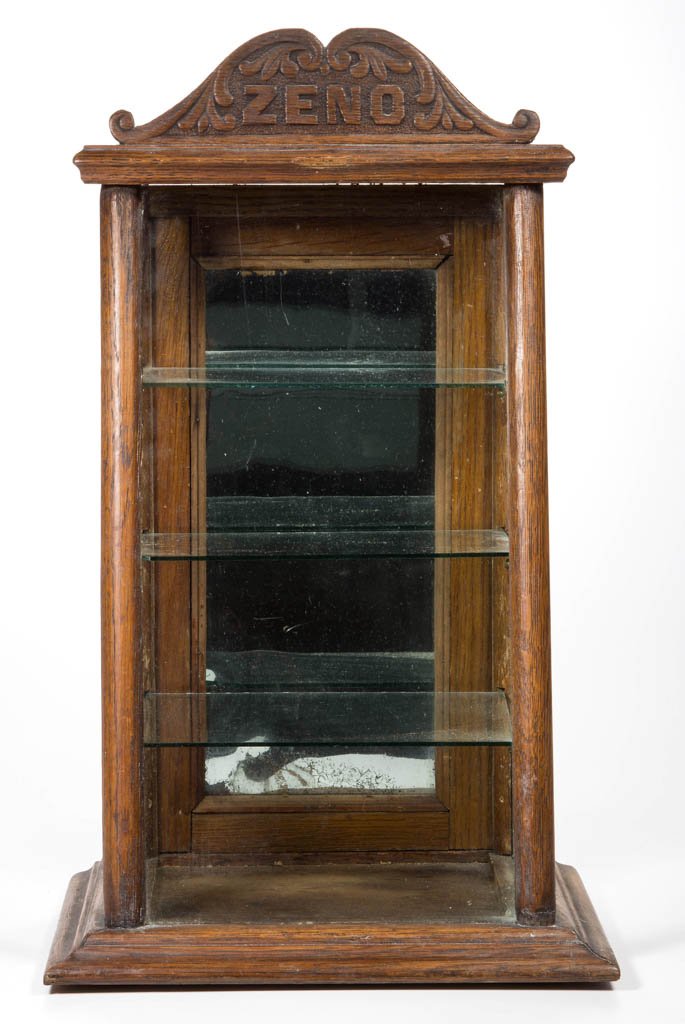 ZENO GUM DIMINUTIVE OAK ADVERTISING SHOWCASE: ZENO GUM DIMINUTIVE OAK ADVERTISING SHOWCASE, featuring original carved pediment or marquee and an old, possibly original finish. First quarter 19th century. 18" HOA, 10 1/2" WOA, 8" DOA. Provenance: