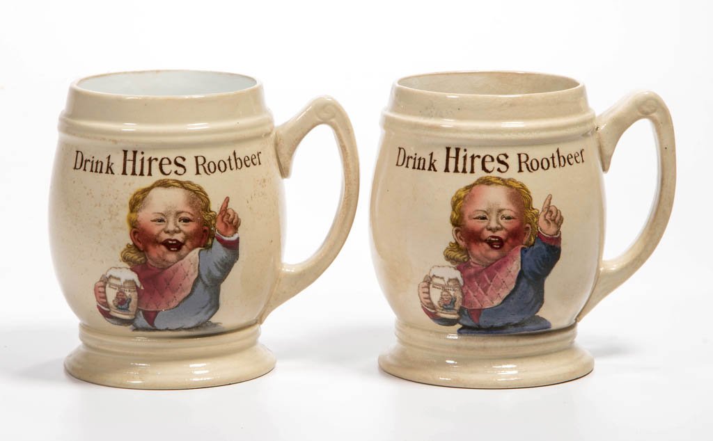 HIRES ROOT BEER CERAMIC ADVERTISING MUGS, LOT OF TWO: HIRES ROOT BEER CERAMIC ADVERTISING MUGS, LOT OF TWO, each featuring an image of a rosy cheek lad holding a frothy mug of "Hires Rootbeer". Each marked "Villeroy & Boch / Mettlach / For The Charles E.