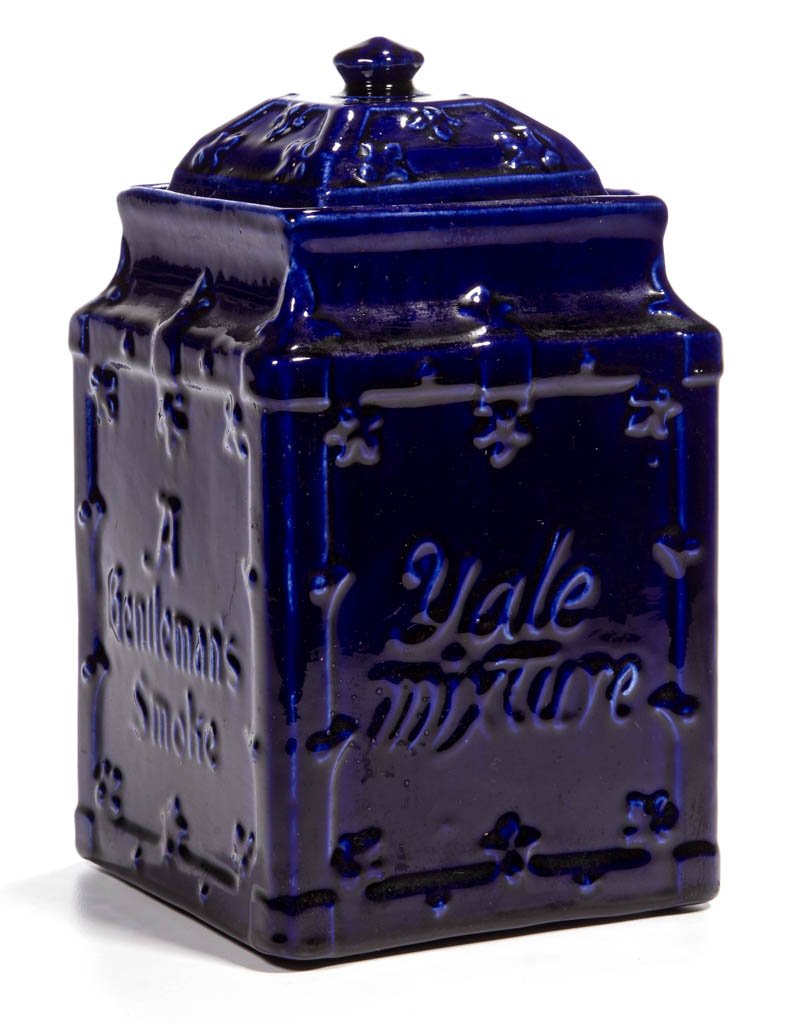 YALE MIXTURE CERAMIC ADVERTISING TOBACCO JAR: YALE MIXTURE CERAMIC ADVERTISING TOBACCO JAR, with molded features, deep blue glaze, and slogans "A Gentleman's Smoke" and "May All Your Troubles End in Smoke" to each side. 20th century. 9" HOA. Prov