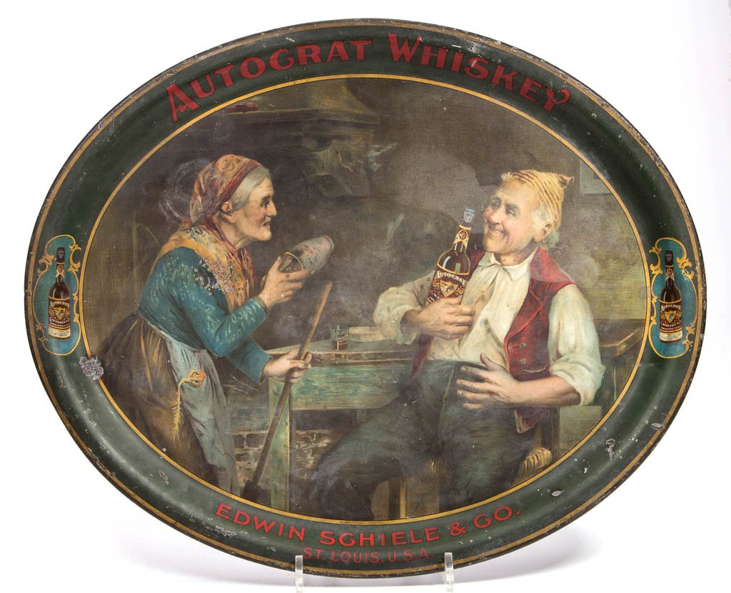 AUTOCRAT WHISKEY ADVERTISING TIN SERVING TRAY: AUTOCRAT WHISKEY ADVERTISING TIN SERVING TRAY, oval, Edwin Schiele & Co., St. Louis, manufactured by the Meek Co., Coshocton, Ohio. Early 20th century. 13 3/4" x 16 1/2". Provenance: Property of a Wes