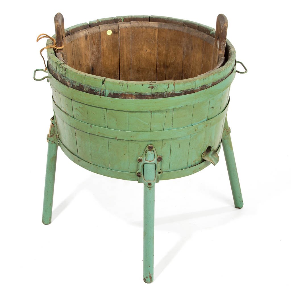 COUNTRY WOODEN WASH TUBS, LOT OF TWO: COUNTRY WOODEN WASH TUBS, LOT OF TWO, one with cut-out handles, the other raised on four legs and with drain spout, older green paint. Late 19th/early 20th century. Green example 27" H, 24 1/2" D. Pro